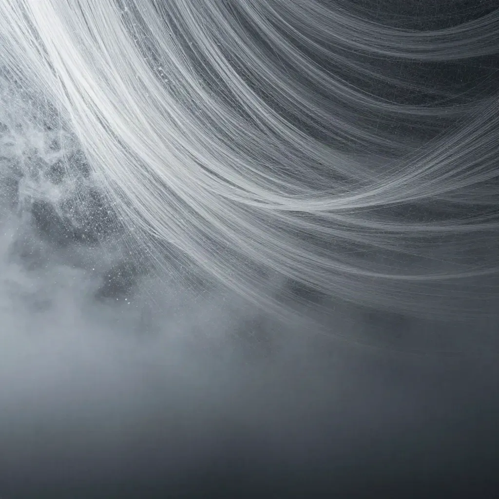 Silver filaments bloom in graphite haze with calm copy space along the lower third.
